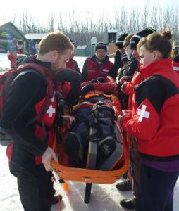 THIS IMAGE: Lake Mountain Ski Patrol volunteers  refresh their skills during a scenario at the 2015 training weekend. HEADER IMAGE:  Patrollers Mac Hanson (left) and Jesse Siebler enjoy Lake Mountain's winter wonderland. 